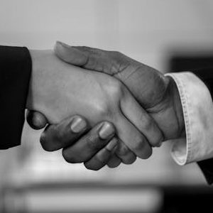 Close-up of a professional handshake in black and white, symbolizing agreement and partnership.